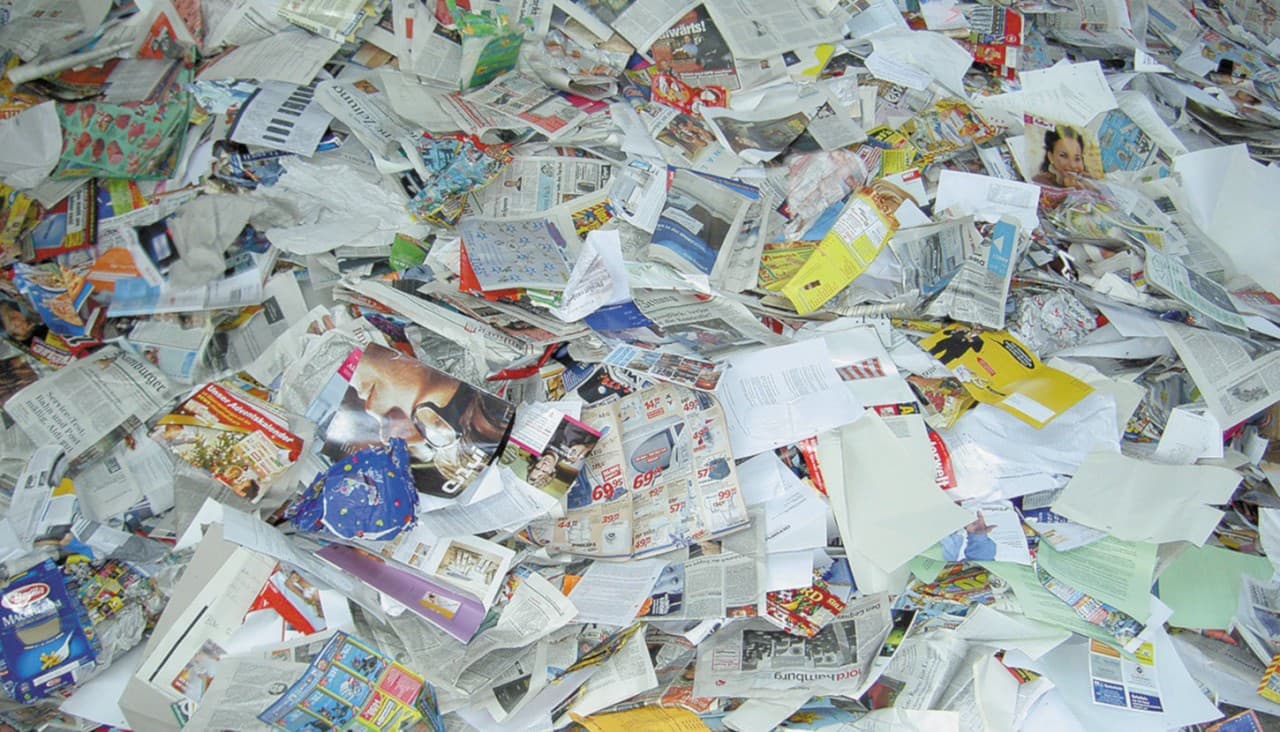 A heap of discarded paper: newspapers, store circulars and advertising inserts